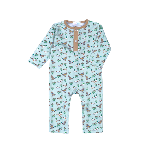 A baby long-sleeve romper in light mint green with an all-over print of corgis and cactus, featuring a tan Henley collar with snap buttons.